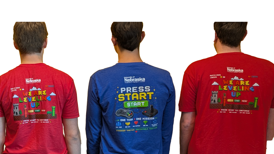 Three individuals wearing red and blue shirts with colorful graphics on the back.